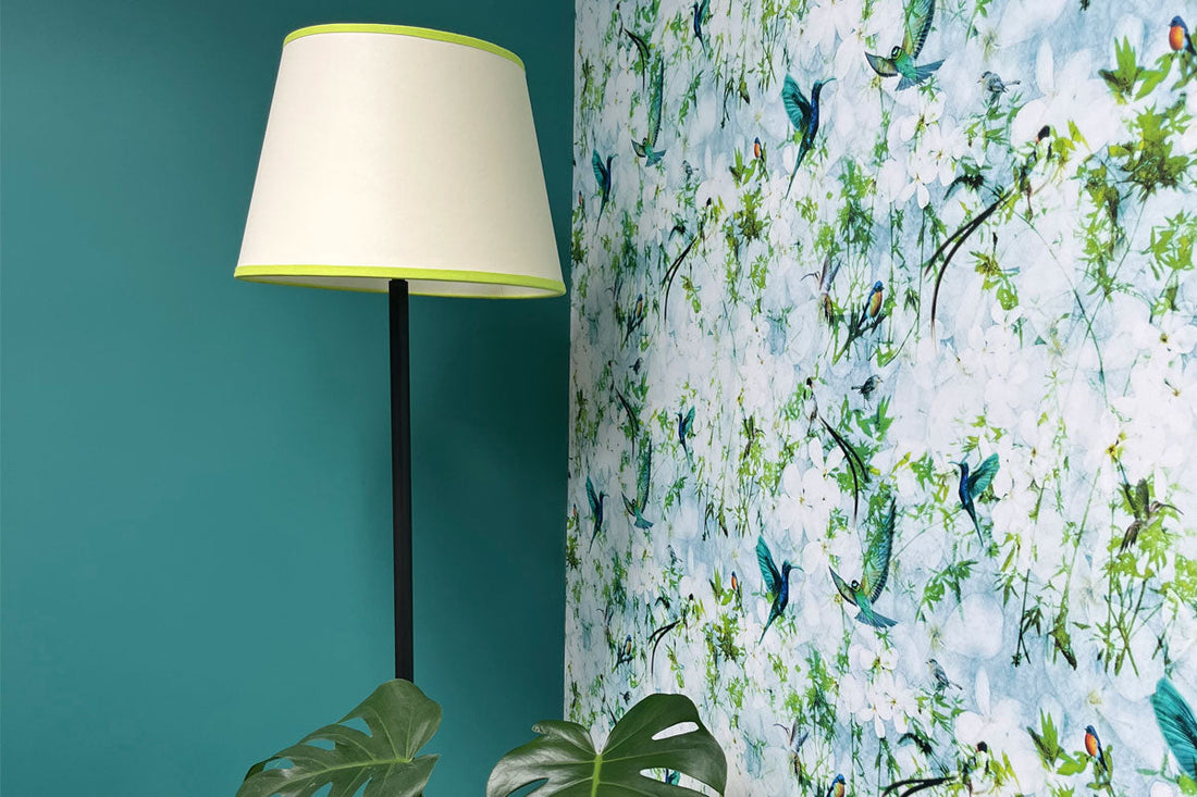 Close up of Birds wallpaper design by ATADesigns in dining room with lampstand.  Interior design by Joanne Jeyes.  The wallpaper features birds in flight on a floral background.  Colour scheme of dining room is teal