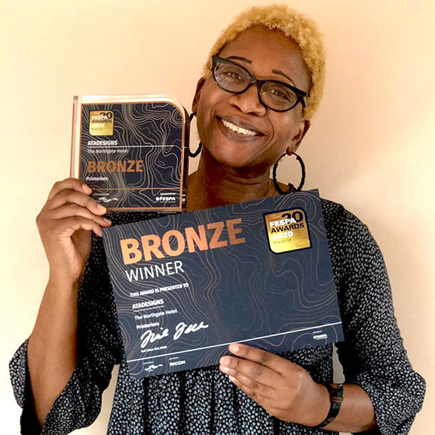 Annette Taylor-Anderson of ATADesigns holding Bronze winner trophy and certificate.  Winner of The Fespa Printinteriors Awards 2020