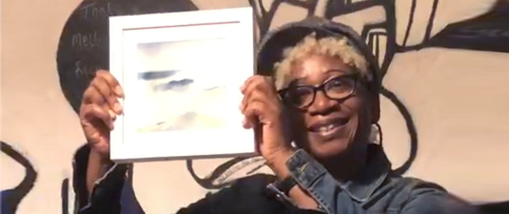 Annette Taylor-Anderson holding prize painting.  Winner of The Solutions Awards 2021