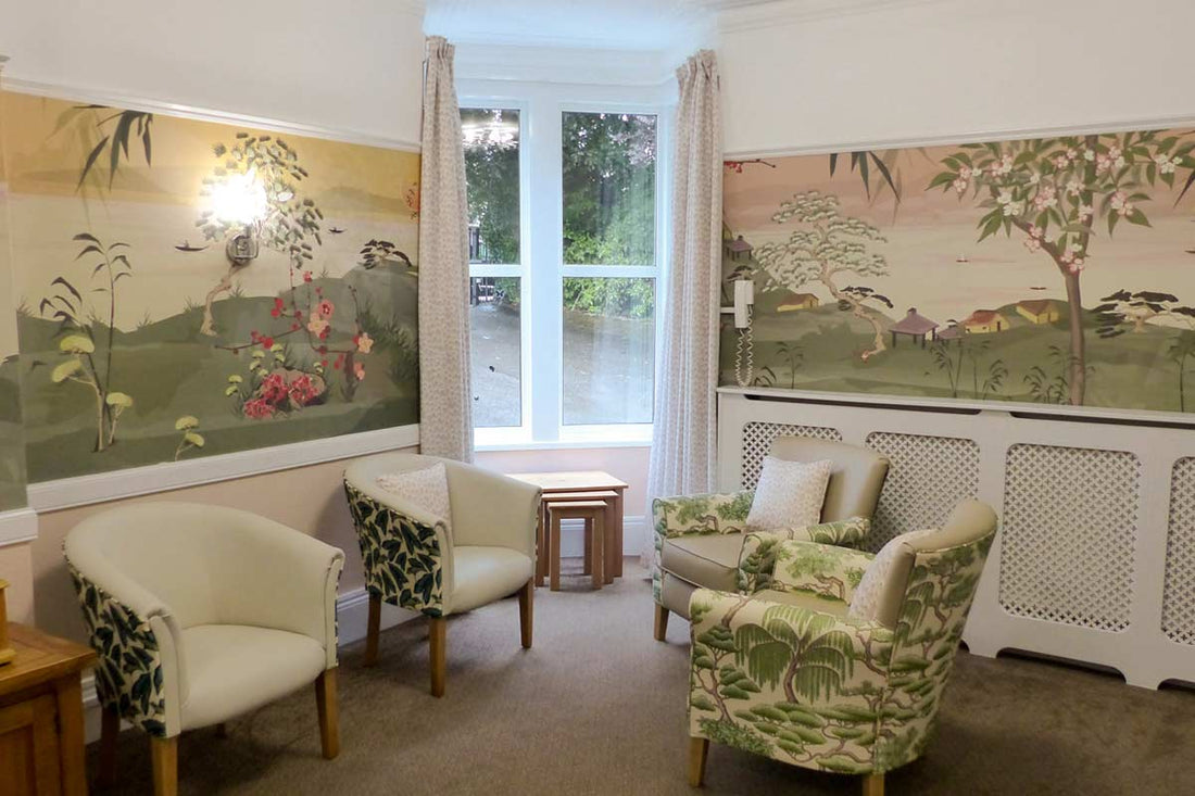 Bespoke Japanese-inspired mural by ATADesigns in the lounge at Hengrove Lodge Care Home, Bristol — featuring cherry blossom, birds and tranquil water in soft sage greens and blush pinks