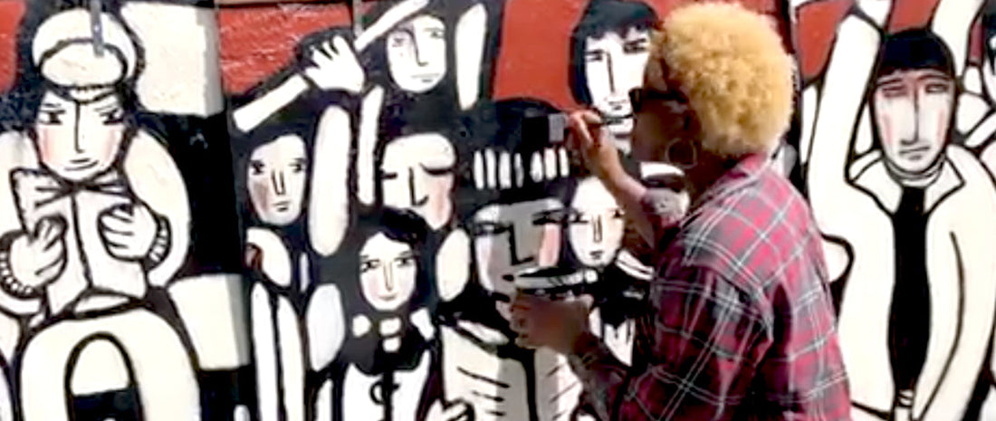 Journey Garden Mural painting.  Annette Taylor-Anderson is painting the mural design on the fence