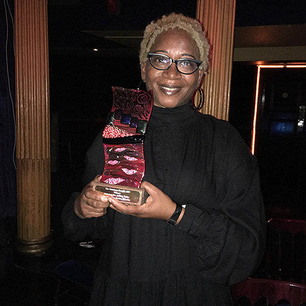 Annette Taylor-Anderson of ATADesigns Winner of The Solutions Award in 2019.  Annette is holding winning trophy.