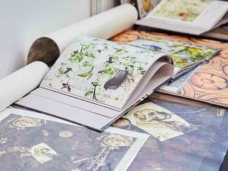 Wallpaper and wallpaper books by ATADesigns laid out on a table