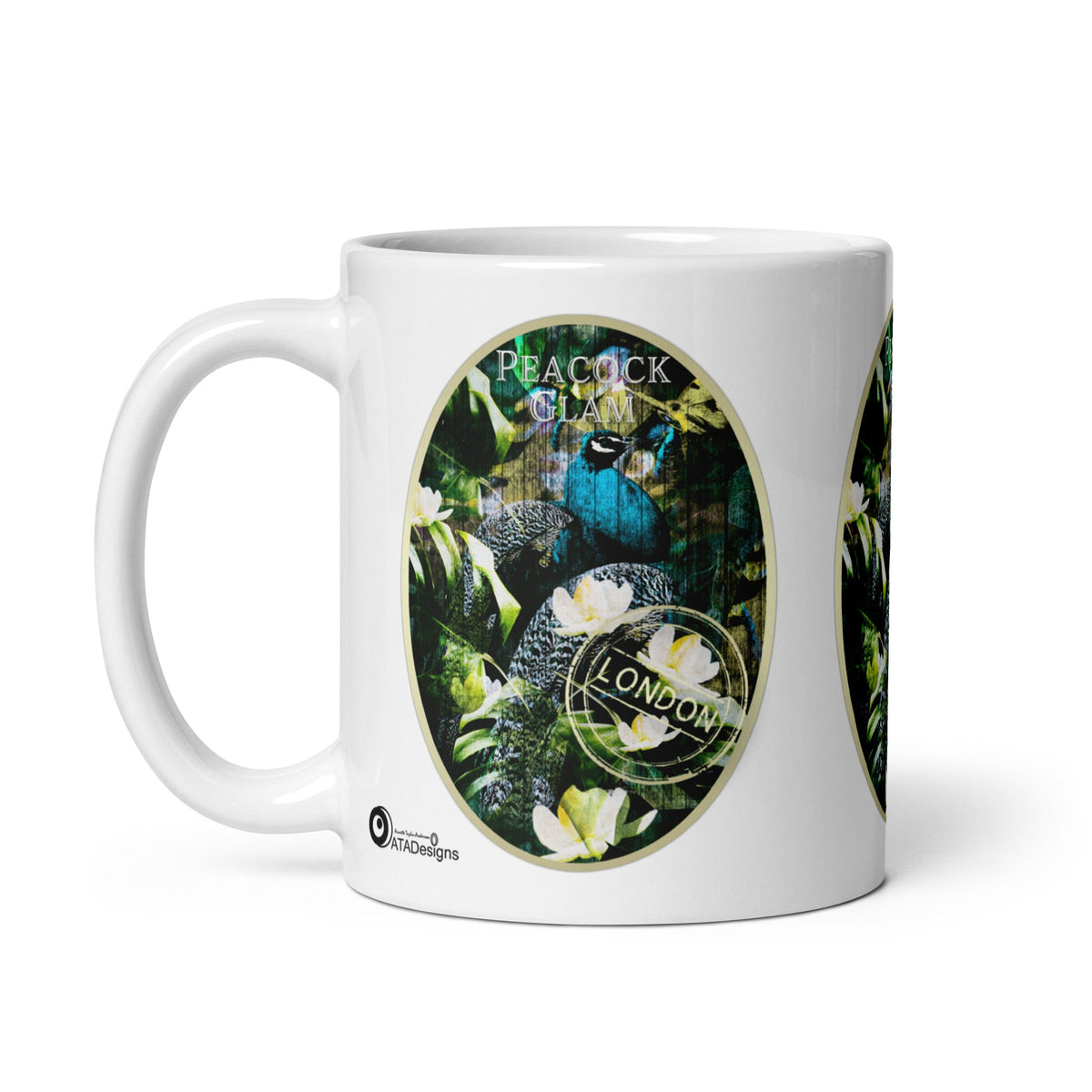 Peacock Glam mug by ATADesigns with a blue peacock, green foliage and white flowers, handle on the left.