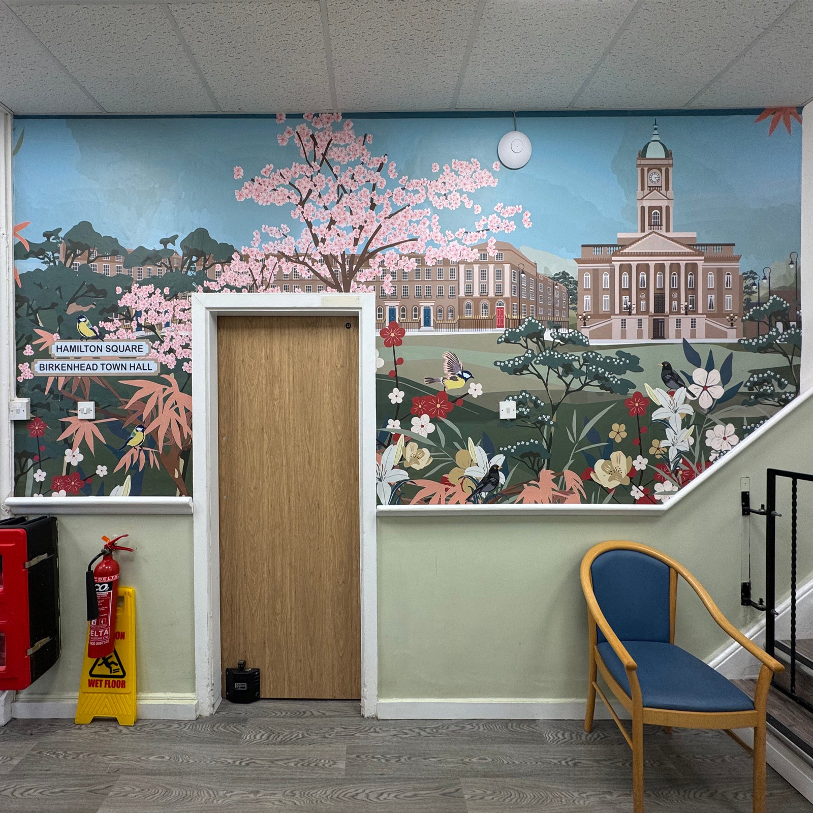 Hamilton Square Mural design featured in corridor with chair.