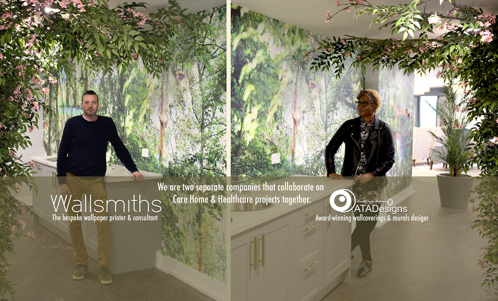 Gareh Wyn Jones of Wallsmiths and Annette Taylor-Anderson of ATADesigns  standing in room featuring forest themed mural in background and artificial trees in the foreground.  Mural design by ATADesigns