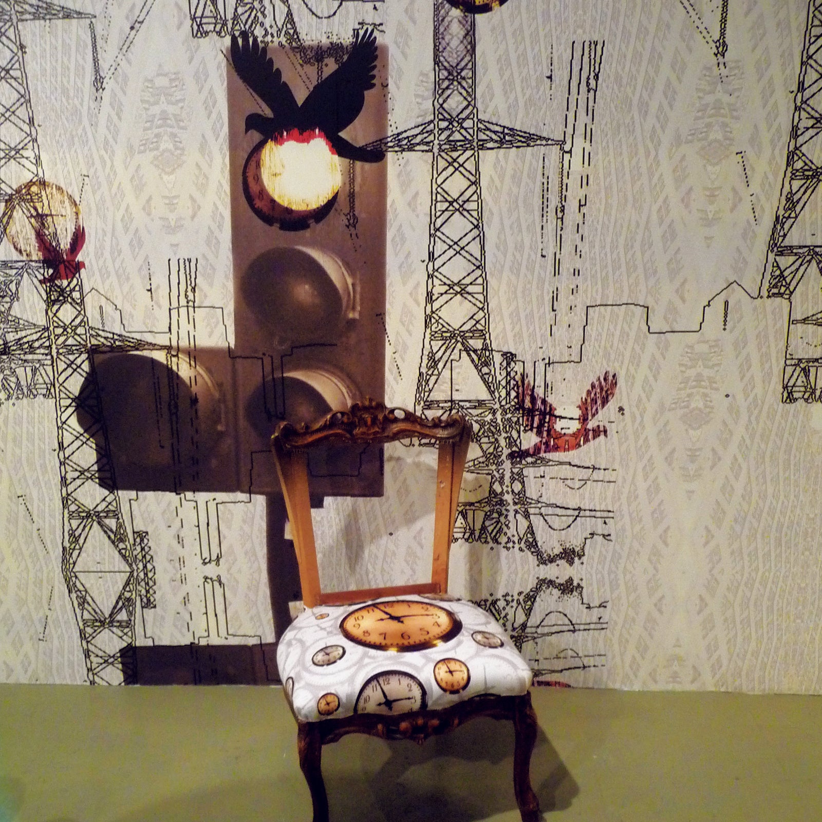 Close up of vintage nursing chair upholstered with floating clocks fabric design by ATADesigns, in front of a mural featuring giant traffic lights, pylons and birds by ATADesigns.  Chair upholstered by Urban Upholstery.  A collaboration project.