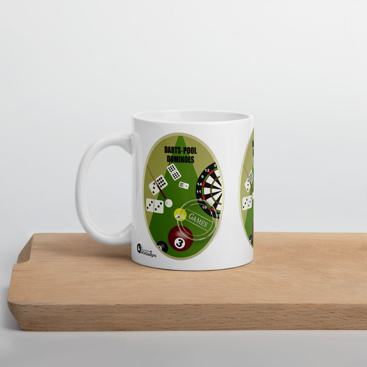 White Darts, Pool & Dominoes mug with a dartboard, dominoes and coloured pool balls, displayed on a wooden board.