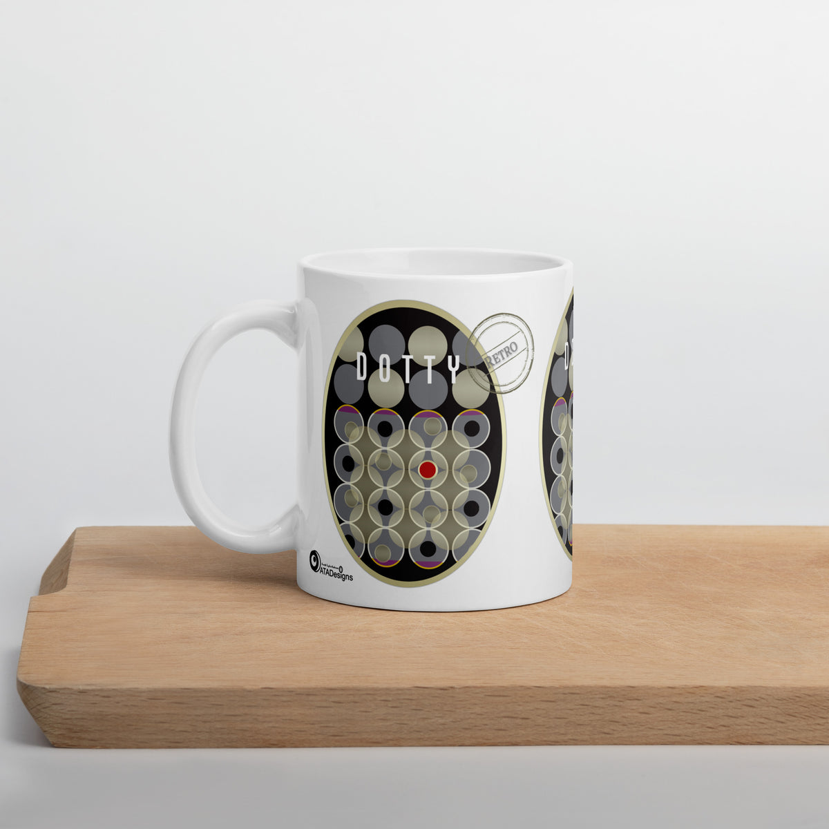White Dotty Retro mug with grey and cream circles and a red accent dot, displayed on a wooden board.