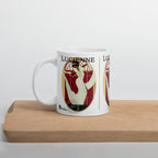 White Lucienne Art Deco mug with a woman in a flowing cream dress and red geometric artwork, displayed on a wooden board.