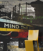 A modern yellow chair positioned in front of a highly textured, grunge-style collage wall mural featuring the phrase 'MIND THE GAP' and industrial imagery. Mural design by ATADesigns.