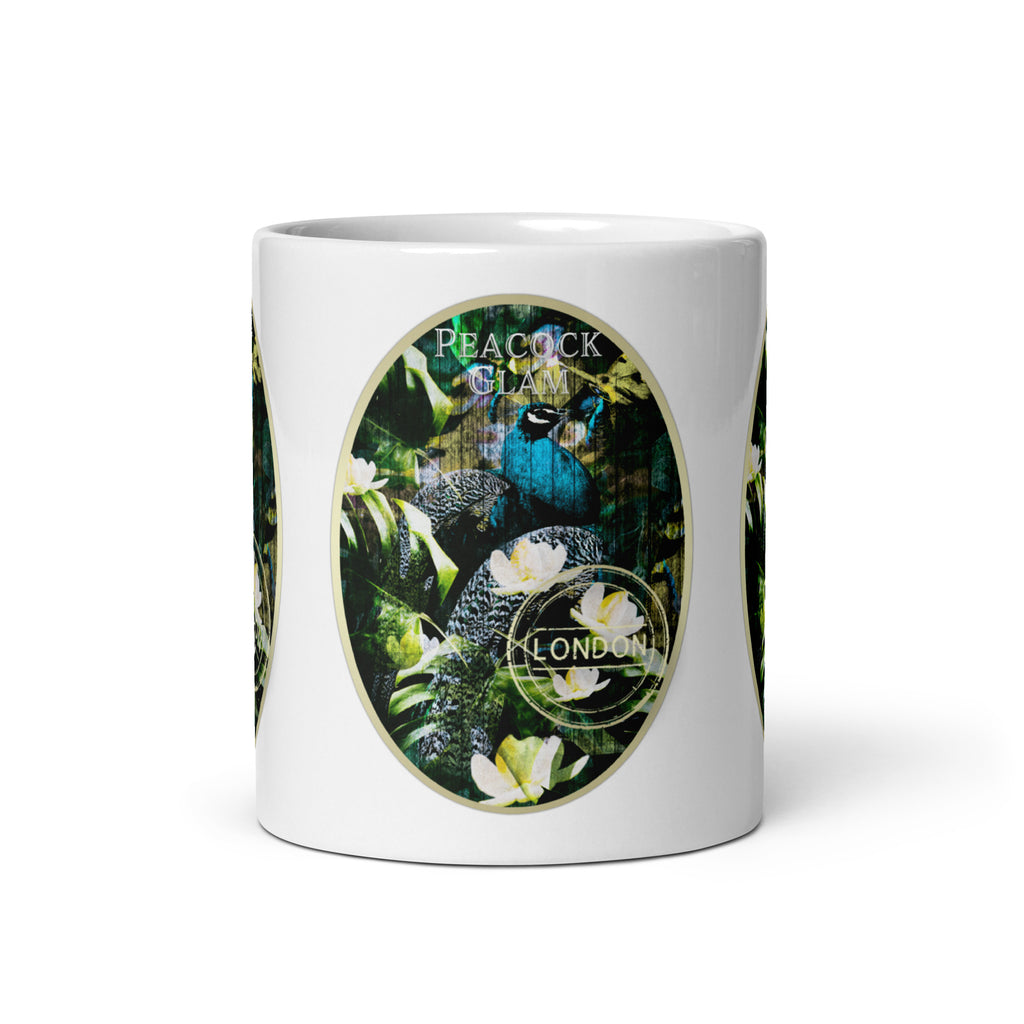 Front view of the Peacock Glam mug, showing a blue peacock among green foliage and white flowers.