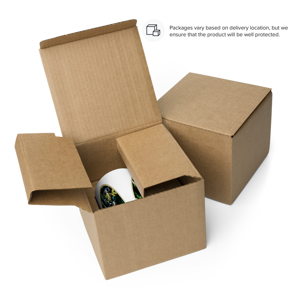 Peacock Glam mug in a cardboard box beside a closed box. Packaging varies by delivery location.