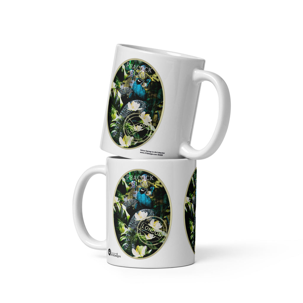 Two stacked Peacock Glam mugs by ATADesigns, each showing a peacock among green foliage and white flowers.