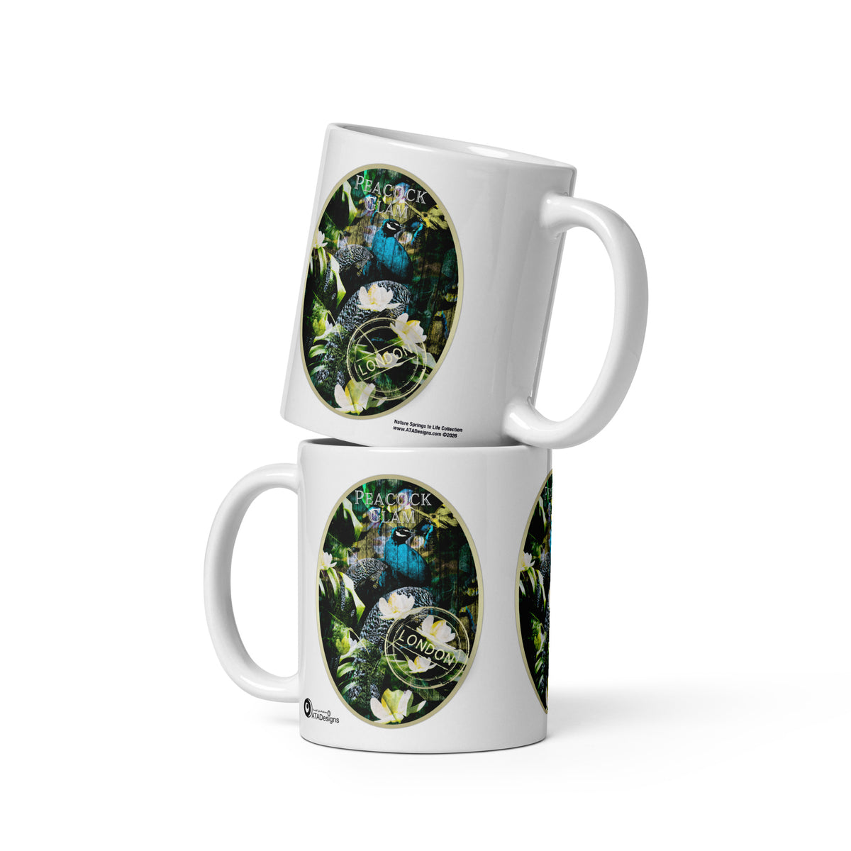 Two stacked Peacock Glam mugs by ATADesigns, each showing a peacock among green foliage and white flowers.