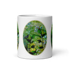 Front view of the Pure Nature mug, showing birds among green foliage and blue flowers.