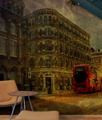 A vintage-style wall mural depicting a London Southwark street scene with a red double-decker bus and old brick buildings, shown installed in an interior setting with a small round table and chair in the foreground. Mural design by ATADesigns.