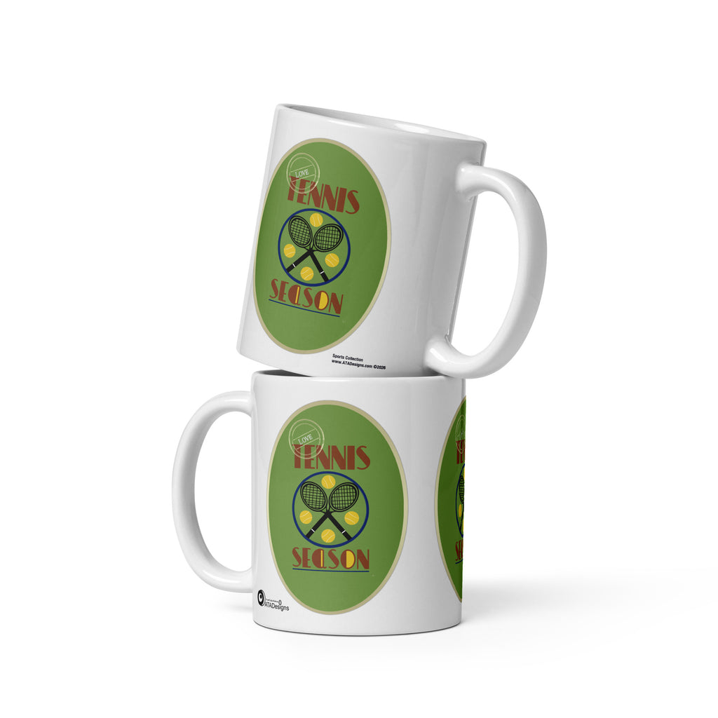 Two stacked white Tennis Season mugs by ATADesigns, showing crossed rackets and yellow tennis balls on green backgrounds.
