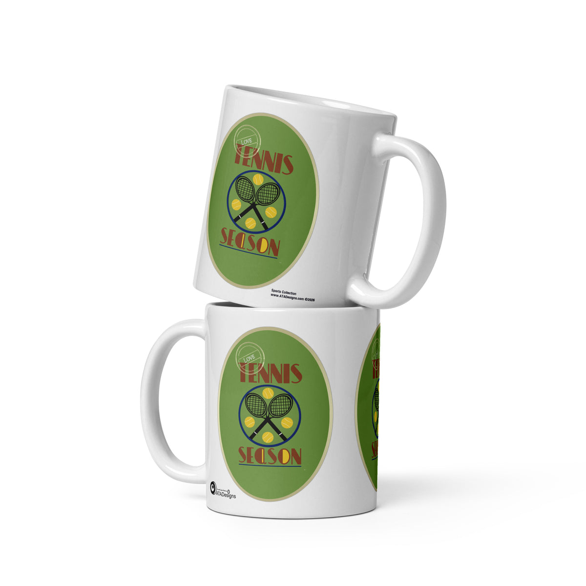 Two stacked white Tennis Season mugs by ATADesigns, showing crossed rackets and yellow tennis balls on green backgrounds.