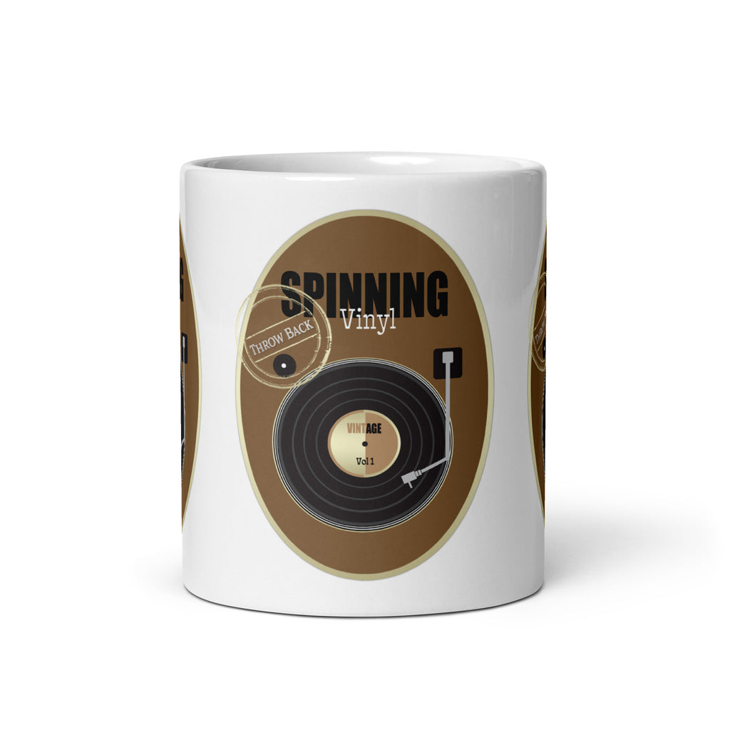 Front view of the Vinyl Retro mug, showing a black record, tone arm and “Spinning Vinyl” lettering on a brown background.