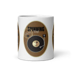 Front view of the Vinyl Retro mug, showing a black record, tone arm and “Spinning Vinyl” lettering on a brown background.